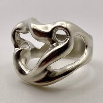 Silver ring with a unique design on a light gray background