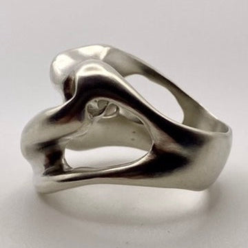 Silver ring with a unique design on a light gray background