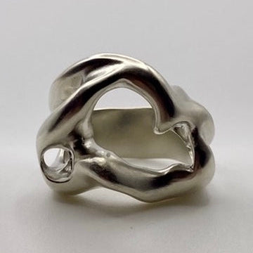 Silver ring with a unique design on a light gray background