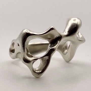 Silver ring with a unique design on a light gray background