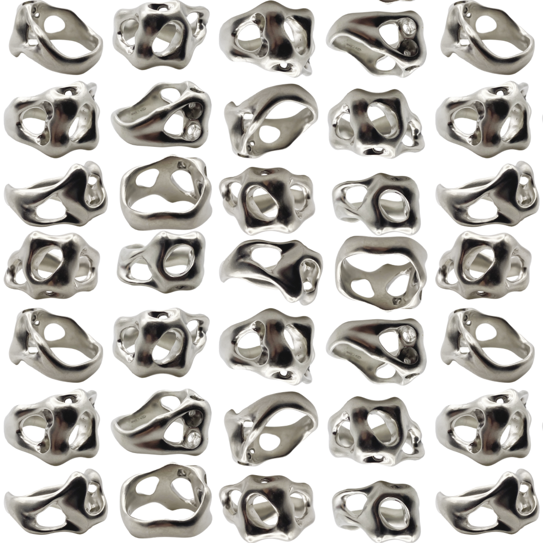 Pattern of metallic sterling silver rings on a white background