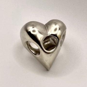 Sterling silver heart-shaped ring on a light gray background