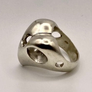 Sterling silver heart-shaped ring on a light gray background