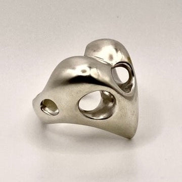 Sterling silver heart-shaped ring on a light gray background